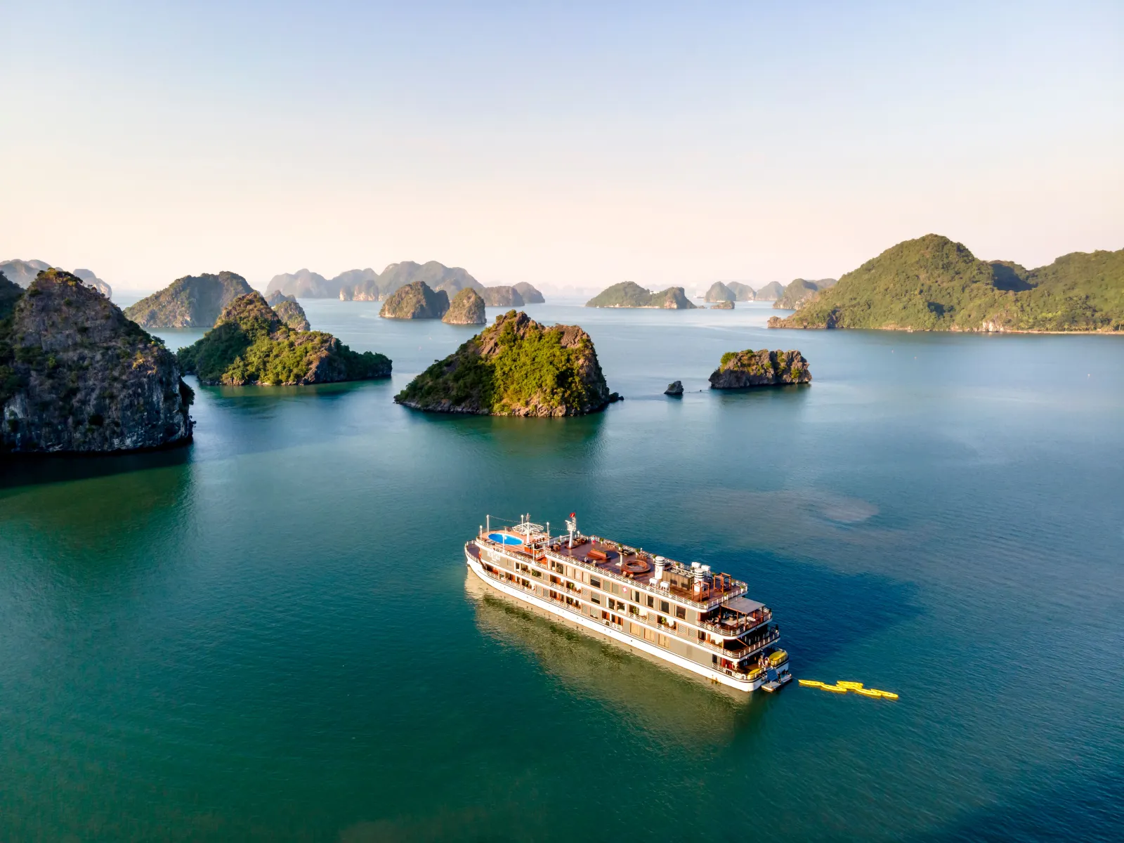 Explorer la baie de Hạ Long : trois piliers d'un archipel calcaire suspendu entre ciel et mer